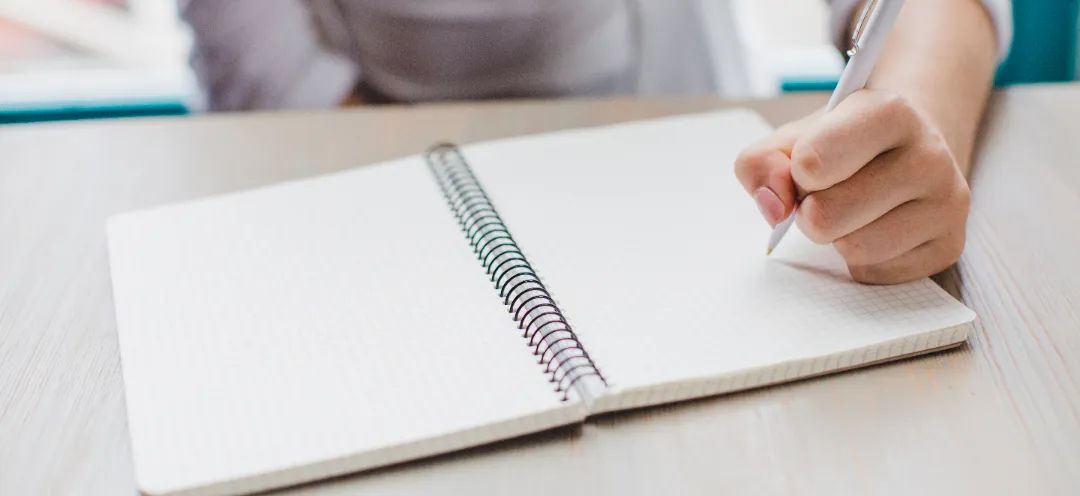anonymous-woman-writing-notepad.jpg